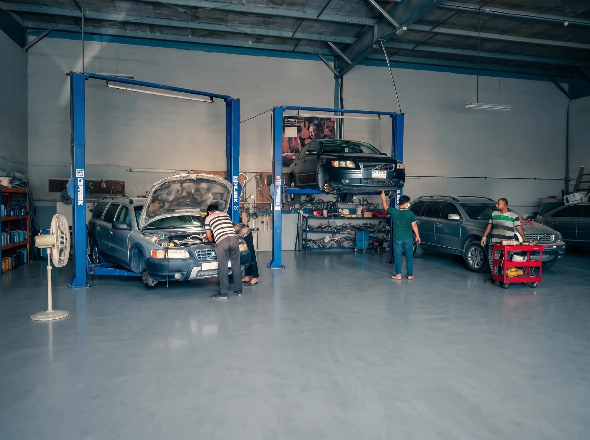 Volvo XC70 and S40 on two-post lifts inside the Volvo Auto Service workshop in Sharjah